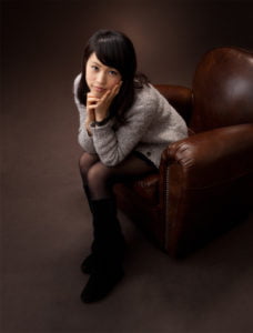 椅子に座って上を見つめる女性