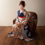椅子に座った振袖を着た二十歳の全身