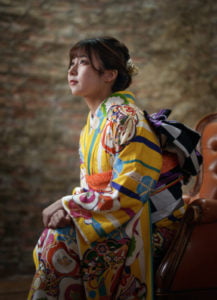椅子に座った振袖を着た二十歳の女性